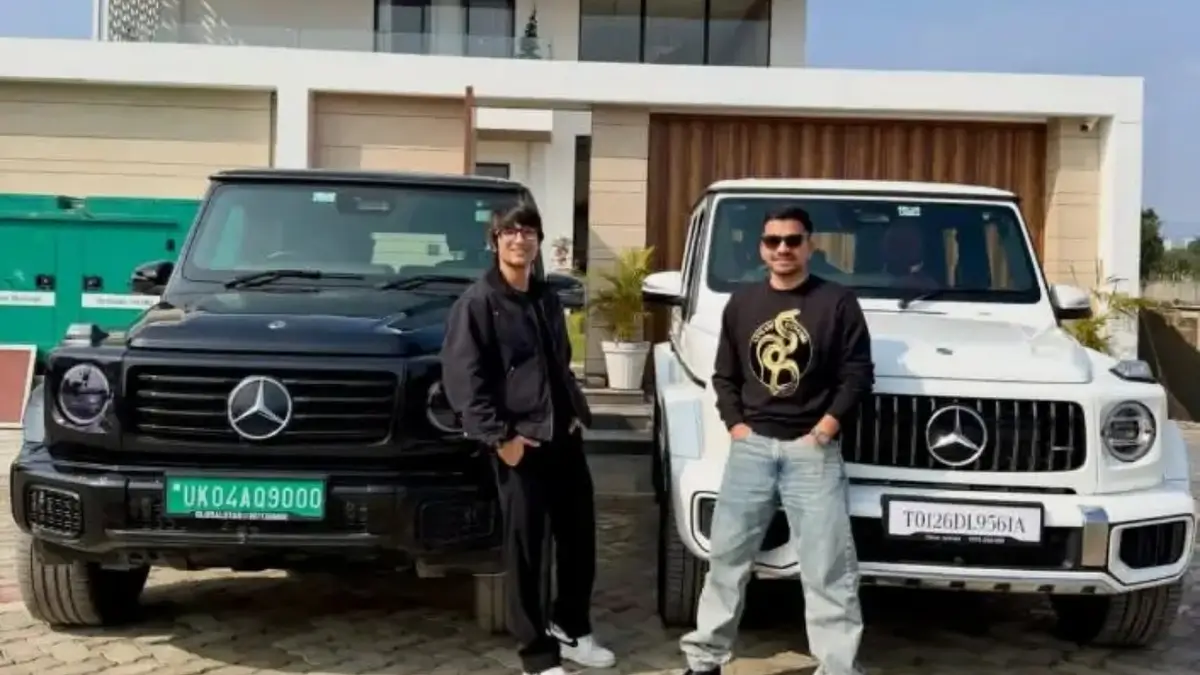 Sourav Joshi standing with black and white Mercedes-Benz G-Class SUVs outside a luxury house